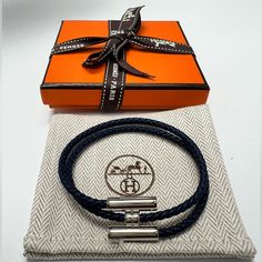 Hard To Find Colorbrand New Hermes Tournis Tresse Bracelet, Navy, Size T5, Palladium-Plated Hardware With Swift Calfskin. Made In Italy. Braid Width 0.12. Comes With Original Box, Ribbon, And Dust Bag. No Refunds After Purchase. Men Hermes Bracelet, Mens Hermes Bracelet, Hermes Men Bracelet, Hermes Ring, Hermes Men, Hermes Bracelet, Box Ribbon, Wrap Bangles, Hook Bracelet