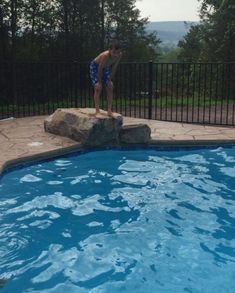 a man standing on the edge of a swimming pool