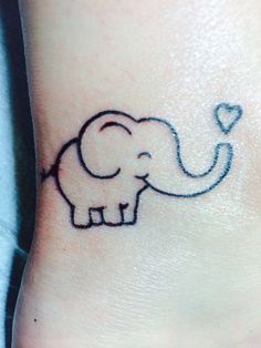 an elephant with a heart tattoo on its foot