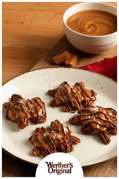 some kind of dessert on a plate next to a cup of coffee and cinnamon sticks