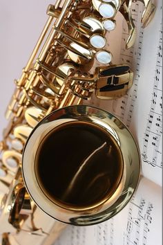 a saxophone sitting on top of sheet music