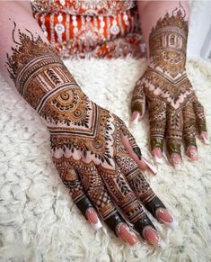 a woman's hands with hennap on it, and her hand painted