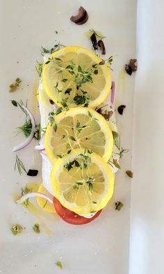 sliced lemons and onions on a white surface