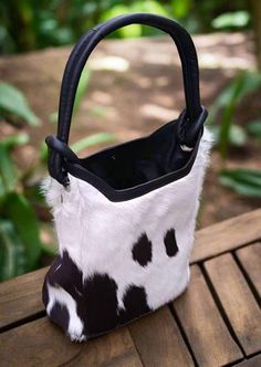 Indulge in the opulence of this exquisite black and white cowhide leather bucket bag by Custom Jackets n Bags. Designed to be roomy and adaptable, it features a magnetic fastening, internal zip pocket with canvas lining. Handcrafted with exceptional skill, this carry-all shoulder bag is ideal for the contemporary woman on the move. Elevate your style with this remarkable accessory. 1- black & White Cowhide. 2- Natural black Leather. 3- Magnetic Main opening. 4- 1 small zip pocket inside. 5- Mobi Black Calf Hair Bags For Everyday Use, Black Calf Hair Bag For Everyday Use, Everyday Black Calf Hair Bag, White Leather Hobo Bag With Top Carry Handle, Black Calf Hair Bag With Leather Handles, Calf Hair Satchel Bag, Rectangular Calf Hair Bag For Shopping, Calf Hair Rectangular Shopping Bag, Black Calf Hair Rectangular Bag