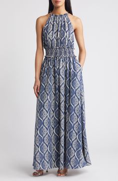 A bold allover print brightens the look of a carefree maxi dress structured with a smocked waist. 55" center front length (size Medium) Ties at back Halter neck Smocked waist Side-seam pockets Lined 100% polyester Machine wash, dry flat Imported