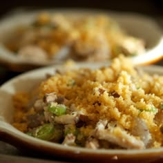 two bowls filled with food on top of a table