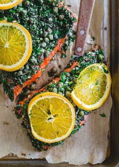 fish with lemons, capers and peas on it