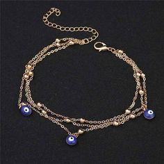 Must-have summer accessory! This beautiful anklet is three chains with silvery beads and three bezel set evil eye charms dangling gracefully between. Wear with your flip flops, strappy sandals, or bare feet for a feminine, sexy look! Wear one on each ankle for a boho-glam effect. Available in silver or gold tone. Can also be worn loose as a bracelet for larger sized wrists. Size: 8.75 inches long with 1.5-inch chain extension. Material: Alloy, resin beads Comes in a gift box (Reg Price $28.95) Adjustable Metal Dangle Anklets, Summer Beaded Metal Bracelets, Summer Metal Beaded Bracelets, Beach Anklets With Adjustable Metal Chain, Trendy Evil Eye Jewelry For Summer, Adjustable Metal Anklets For Summer, Bohemian Metal Anklets With Adjustable Chain, Bohemian Anklets With Adjustable Chain, Silver Bohemian Evil Eye Bracelet