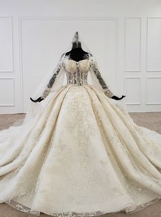 a wedding dress on display in a white room