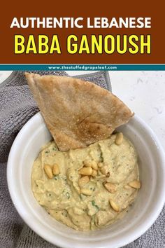 A vibrant bowl of baba ganoush with parsley garnish, surrounded by pita bread slices. The image advertises the dish as 'Authentic Lebanese Baba Ganoush. Lebanese Hummus Recipe, Lebanese Hummus, Syrian Food, Baba Ganoush, Roasted Eggplant, Roast Eggplant, Toasted Pine Nuts, Grape Leaf