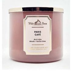 a candle that is sitting in front of a white background with the words paris cafe on it