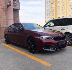 two cars parked next to each other in a parking lot