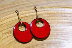 These small to medium-sized bright red earrings make a great eye-catching statement without being over-the-top big.  Great with bold prints, but also amazing as a pop of color with neutrals like white or navy.  Super versatile.  The color is a true primary red, with some dark flecks from firing to add interest.  Want this color in a different shape or size?  Try here!  https://www.etsy.com/listing/1314574745/handmade-bright-red-earrings-customize I make all my enamel components in my home studio Hypoallergenic Red Round Jewelry, Hypoallergenic Red Earrings For Gift, Red Enamel Round Earrings, Red Round Enamel Earrings, Nickel-free Red Round Earrings, Nickel Free Red Earrings, Handmade Red Enamel Jewelry, Red Pierced Enamel Earrings, Red Enamel Pierced Earrings