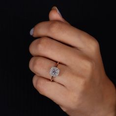 a woman's hand with a diamond ring on it