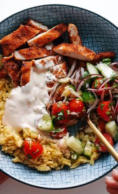 a bowl filled with rice, meat and veggies