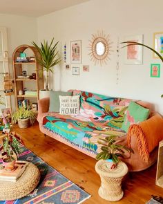 a living room filled with furniture and plants