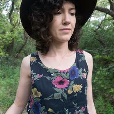 "Vintage 80's black sleeveless top in black soft cotton gauze with dark pastel flowers.  Feels weightless on the body, perfect for the hot summer days! Can be paired with its matching button up shirt, for a layered look: https://www.etsy.com/il-en/listing/806121773/vintage-80s-black-cotton-gauze-button-up TAG: Take Away Made in India CONDITION: Good vintage condition Fabric has some wear FABRIC: Cotton gauze SIZE: Fits like a medium MEASUREMENTS: bust (armpit to armpit): 43 cm length: 59 cm For reference, the model is 1.7m (5'7\") and size XS/S. All measurements are taken flat." Black Floral Print Tank Top For Spring, Black Floral Print Tank Top For Summer, Sleeveless Tops For Summer Garden Party, Vintage Tank Top For Beach In Spring, Vintage Summer Tops For Garden Party, Vintage Tops For Garden Party In Summer, Black Bohemian Tank Top For Summer, Dark Pastel, Goddess Necklace