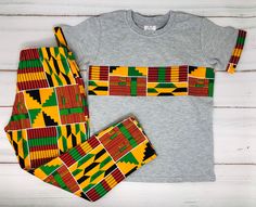 Boy Outfit Set / African Boy Outfit / Ankara Pants Outfit / Kente Print Outfit This 2 piece set comes with a pants and a shirt with a Matching  African print detail. The pants are comfortable for your little one to move around and beautiful and bright at the same time. African Print Pants Outfit comes in multiple prints. Please do not hesitate to contact me if you need some thing different. Print Pants Outfit, Ankara Pants, Ankara Outfits, African Print Pants, Printed Pants Outfits, Kente Print, African Print Skirt, African Dresses For Kids, African Children