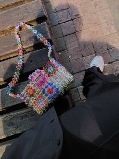 Elevate your style with the Handmade Beaded Bag, a unique accessory that exudes charm and individuality. Featuring delicate beadwork and crystal accents, this custom-designed bag stands out with its Rainbow Bag, Square Bag and Granny Square Purse options, allowing you to choose the perfect match for your personal style. Meticulously crafted by hand, this bag embodies the essence of handmade artistry, delivering a sense of exclusivity with every use. A part of our Beaded Bags collection, this acc Everyday Rectangular Shoulder Bag With Colorful Beads, Beaded Shoulder Bag As Fashion Accessory, Square Beaded Bag For Everyday Use, Multicolor Beaded Pouch Bag, Multicolor Beaded Handheld Shoulder Bag, Bohemian Rectangular Bag With Colorful Beads, Rectangular Beaded Crochet Bag For Daily Use, Trendy Multicolor Beaded Shoulder Bag, Trendy Multicolor Beaded Bags