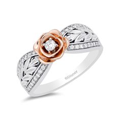 a white and rose gold ring with diamonds on the band, set in two tone gold