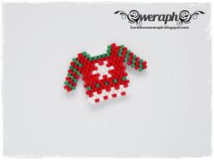 an ornament made to look like a sweater with red, white and green beads