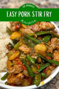 an easy pork stir fry with green beans and potatoes in a white bowl on top of rice