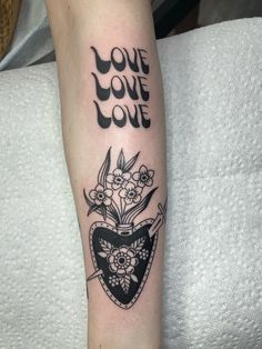 a black and white tattoo with the words love on it