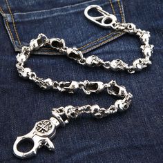 Phantom Skull 925 Sterling Silver Biker Wallet Chain New   Constructed from premium 925 sterling silver;  The clasp carries 925 hallmark;   Weight: approximately 216 grams;   Length: 23” (58 cm);  Link width: 0.6” (15 mm);  Hand-made piece.   It doesn’t get more badass than a display of ferocious skulls. With Phantom Skull 925 Sterling Silver Biker Wallet Chain brought to you by Bikerringshop, you’ll be able to take your biker style up a notch. This piece is equally epic, well-made, and audaciou Skull Wallet, Wallet Chains, Biker Wallet, Small Skull, Biker Jewelry, Belt Accessories, Biker Style, Wallet Chain, Cleaning Jewelry