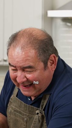 a man in an apron is smiling and holding a knife