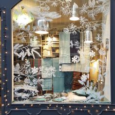 a window display with snowflakes and other items in it's windowsill