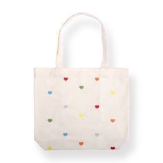 a white bag with multicolored hearts on the front and bottom, sitting against a white background