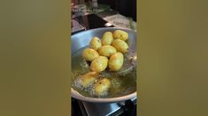 some food is being cooked in a frying pan on the stove top burner