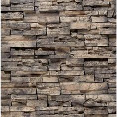 a stone wall that has been made out of different types of rocks and is brown