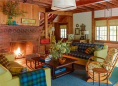 a living room filled with furniture and a fire place