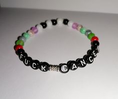 This a personized bracelet. You can choose between black round flat letter needs with with white letter A-Z and black rounded square breeds with colored letter A-Z (orange, yellow, green, blue, purple, hot pink, light pink). And you can also get your Favorit colors on the beds for the rest of the bracelet. You can choose between elastic bracelet or a non elastic bracelet that you can adjust the length yourself. Multicolor Round Beads Jewelry With Letter Print, Multicolor Letter Print Round Bead Jewelry, Multicolor Letter Print Round Beads Jewelry, Trendy Letter Bracelets As Gift, Trendy Letter-shaped Bracelets As Gifts, Trendy Multicolor Jewelry With Letter Print, Trendy Adjustable Name Bracelet, Trendy Adjustable Round Name Bracelet, Trendy Black Jewelry With Letter Print