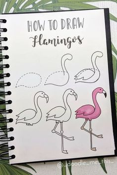 a drawing book with flamingos drawn on it