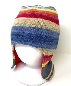 a multicolored knitted hat on a mannequin head