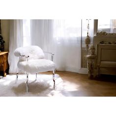 a white chair sitting in front of a window