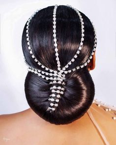 the back of a woman's head with pearls in it