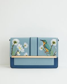 Key Features:



Nature-Inspired Design: Our Kingfisher Green rustic bag from the hero narrative Morning Song brings the essence of the English countryside to your outfit. The pastel blue hue evokes images of rambling meadows and dreamy riversides where our beautiful friend, the Kingfisher, thrives.


Functional Crossbody Strap: Designed with a crossbody strap, offering you the freedom to explore your surroundings on carefree jaunts.


Durable Construction: Crafted from 100% Polyurethane outer a Blue Embroidered Bag For Daily Use, Blue Embroidered Bags For Everyday Use, Blue Rectangular Shoulder Bag With Floral Embroidery, Blue Embroidered Bag For Everyday Use, Embroidered Blue Bag, Embroidered Blue Shoulder Bag For Everyday Use, Blue Embroidered Shoulder Bag For Everyday Use, Everyday Blue Embroidered Bags, Everyday Blue Embroidered Shoulder Bag