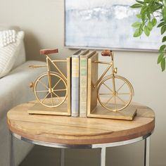 a coffee table with two books and a bike on it in front of a couch