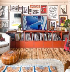 a living room filled with lots of furniture and pictures on the wall above it's bookshelf