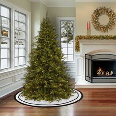 a living room with a christmas tree and fireplace