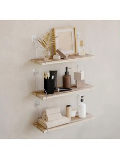 three wooden shelves with various items on them in the corner, and one shelf holding toiletries