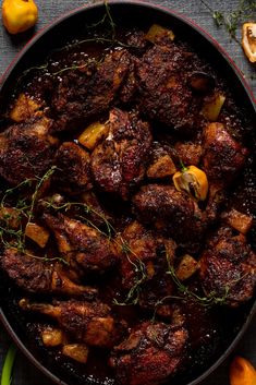 a pan filled with meat and vegetables on top of a table