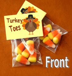 two bags filled with candy sitting on top of a table next to a sign that says turkey toes