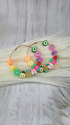 "✨️FREE SHIPPING (USPS First-Class Mail ONLY) and will ship out in ONE BUSINESS Day ✨️ Brighten your look with these playful Clay Fruit Hoop Earrings, a delightful whimsy for your summer and spring outfits. Expertly crafted with gold metal wire bases, each earring is intricately beaded with clay beads and artfully shaped into various vibrant fruits. These earrings celebrate nature's bounty and colors, from juicy watermelons and citrusy oranges to luscious kiwis, creamy avocados, sweet strawberri Colorful Handmade Fun Hoop Earrings, Bohemian Multicolor Hoop Earrings With Large Beads, Novelty Multicolor Summer Jewelry, Summer Novelty Multicolor Jewelry, Fruit Loop Earrings, Fun Multicolor Dangle Hoop Earrings, Playful Multicolor Handmade Hoop Earrings, Playful Handmade Multicolor Hoop Earrings, Playful Multicolor Hoop Jewelry