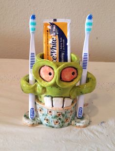 a toothbrush holder made to look like a monster