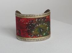 This cuff bracelet is made of hand-painted silk with floral pattern. I painted a red flower with a green and gold pistil on the silk ribbon. * bronze and silk colored metal * width 5 cm * Hand painted floral pattern * High quality French paintings *Heat fixed to preserve colors * Made in Lyon * red, green, bronze * bohemian It's the perfect useful gift to give to please Mother's Day, Wedding Anniversary, Birthdays Sending : beautifully packaged in an organza bag and in a black gift box sent by colissimo to France My store: https://www.etsy.com/fr/shop/SOIEPEINTMAIN https://www.etsy.com/fr/listing/553486013/hand-painted-silk-cuff-bracelet?click_key=cbb5ea00897ae57a3b748fb370f135f79fa00227%3A553486013&click_sum=78bc2099&ref=shop_home_active_262&pro=1 French Paintings, Painted Silk, Bohemian Bracelets, Hand Painted Silk, Black Gift Boxes, Black Gift, Flower Bracelet, Silk Painting, Red Flower