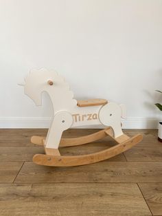 a wooden rocking horse with the word trizzo on it's back and side